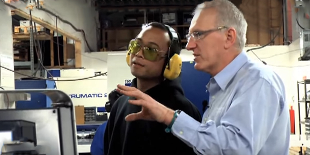 CEO Ed Beange consults with manufacturing employee in sheet metal shop