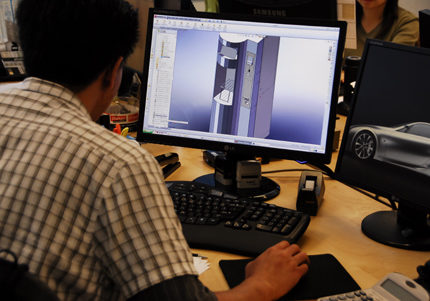 Hansen employee working on computer CAD system