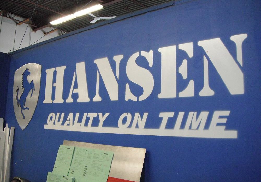 Hansen Industries machine displaying moto "quality on time"